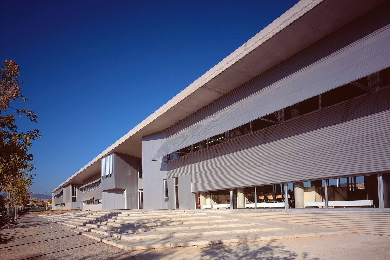 Side view of the High School showcasing the building's linear design with extensive use of windows and external shading devices.