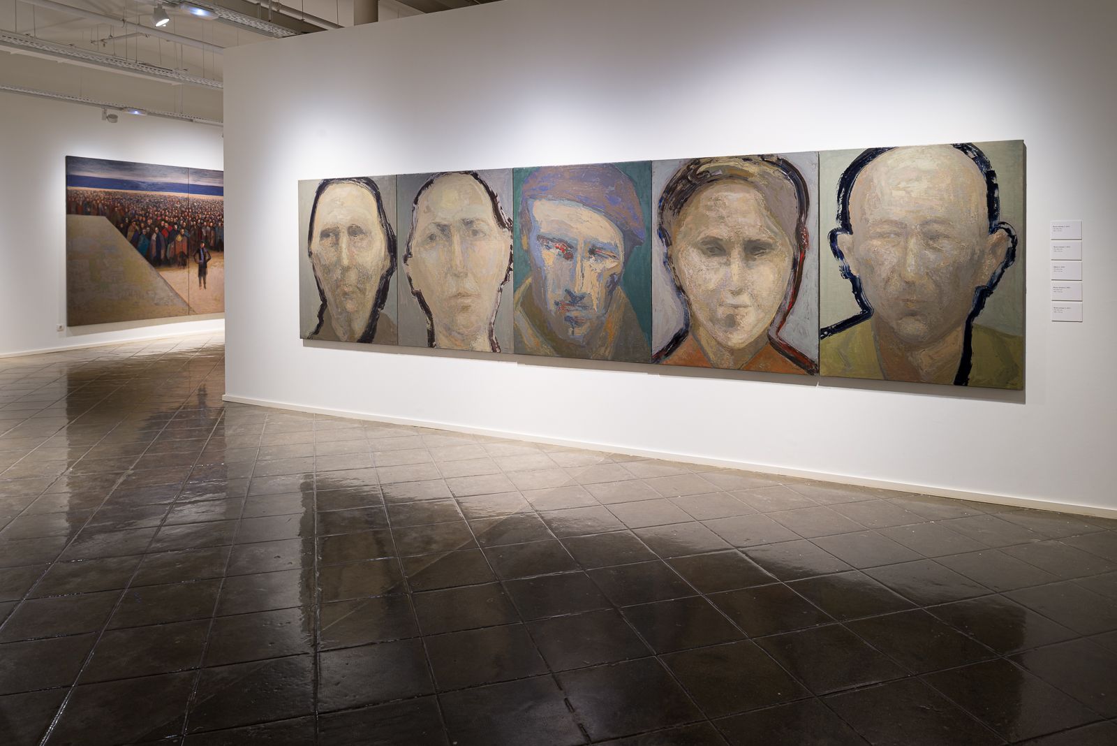 Gallery showcasing five large portrait paintings in a row on the right wall and a large mural painting in the background.